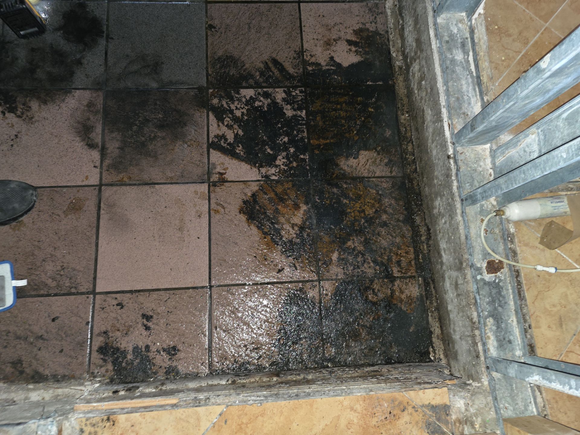 Heavy soot and smoke damage covering tile floor after fire